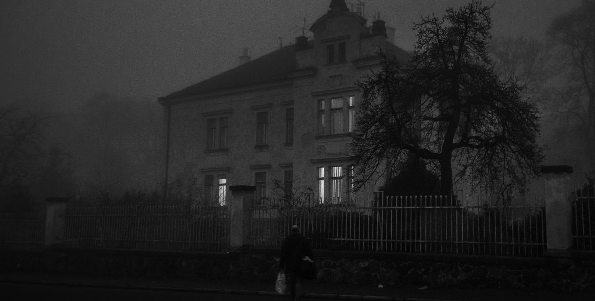 house at night with person walking up