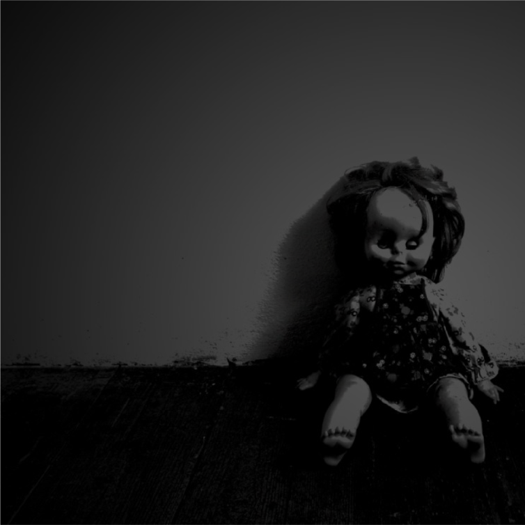 Old doll propped up against a wall