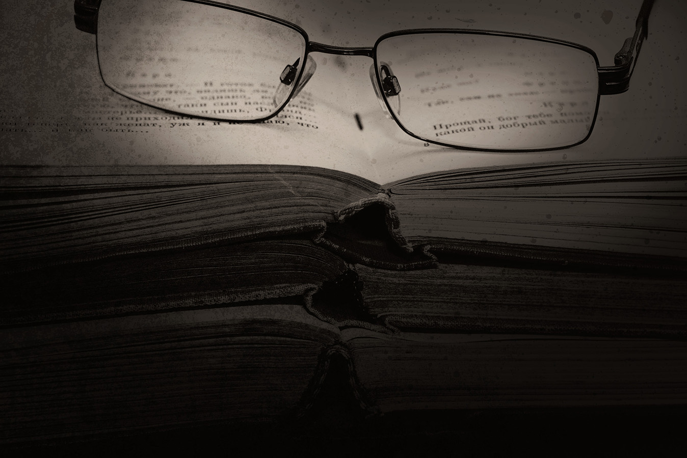 reading glasses sitting on a stack of books